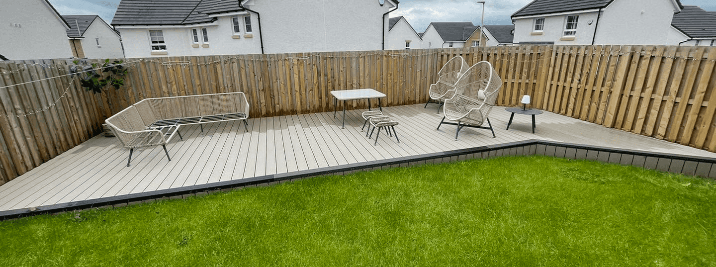 A new build Taylor Wimpey style of the cream to white variety this is the back garden, it is new decking at the back of the garden with a wooden fence all around it just been power washed and looking great