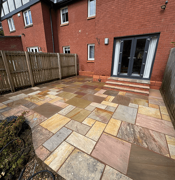 More modern type of red bricked semi detached property with a clean patio after it has been power washed