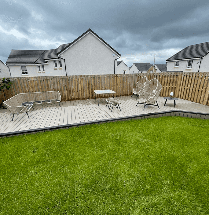 A new build Taylor Wimpey style of the cream to white variety this is the back garden, it is new decking at the back of the garden with a wooden fence all around it just been power washed and looking great