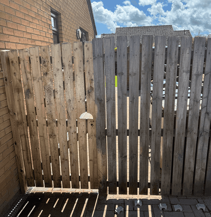 Wooden Gate with door at the side of a home looking really bright and clean after being power washed