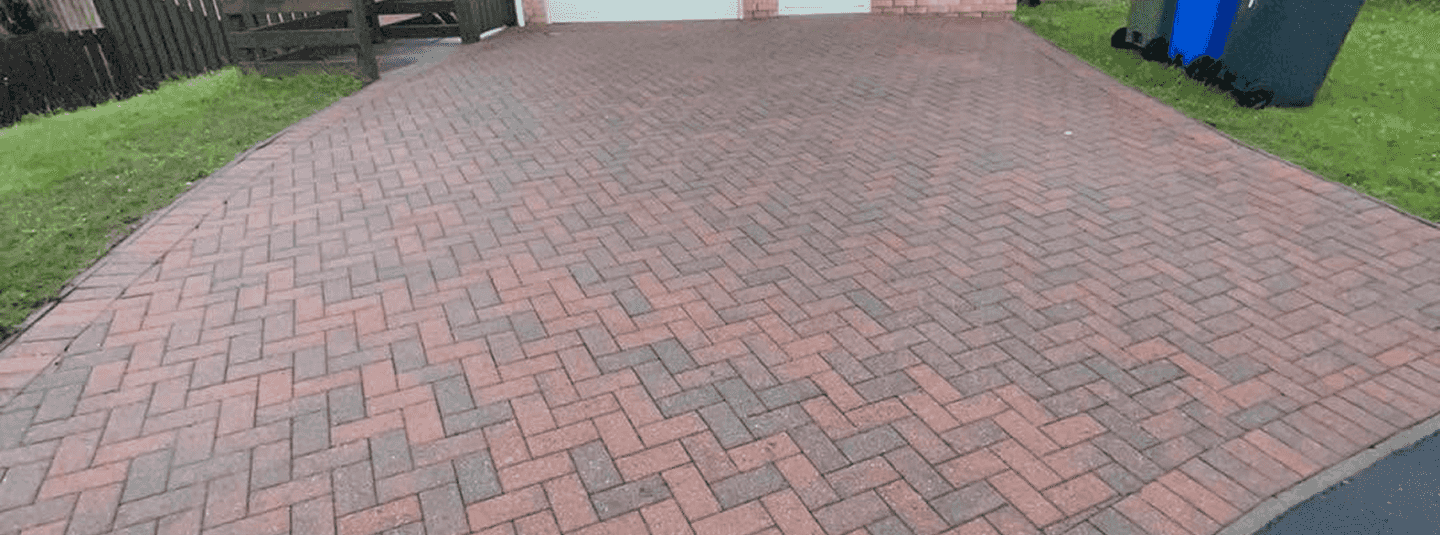 A perfectly post power wash cleaned red concrete patio